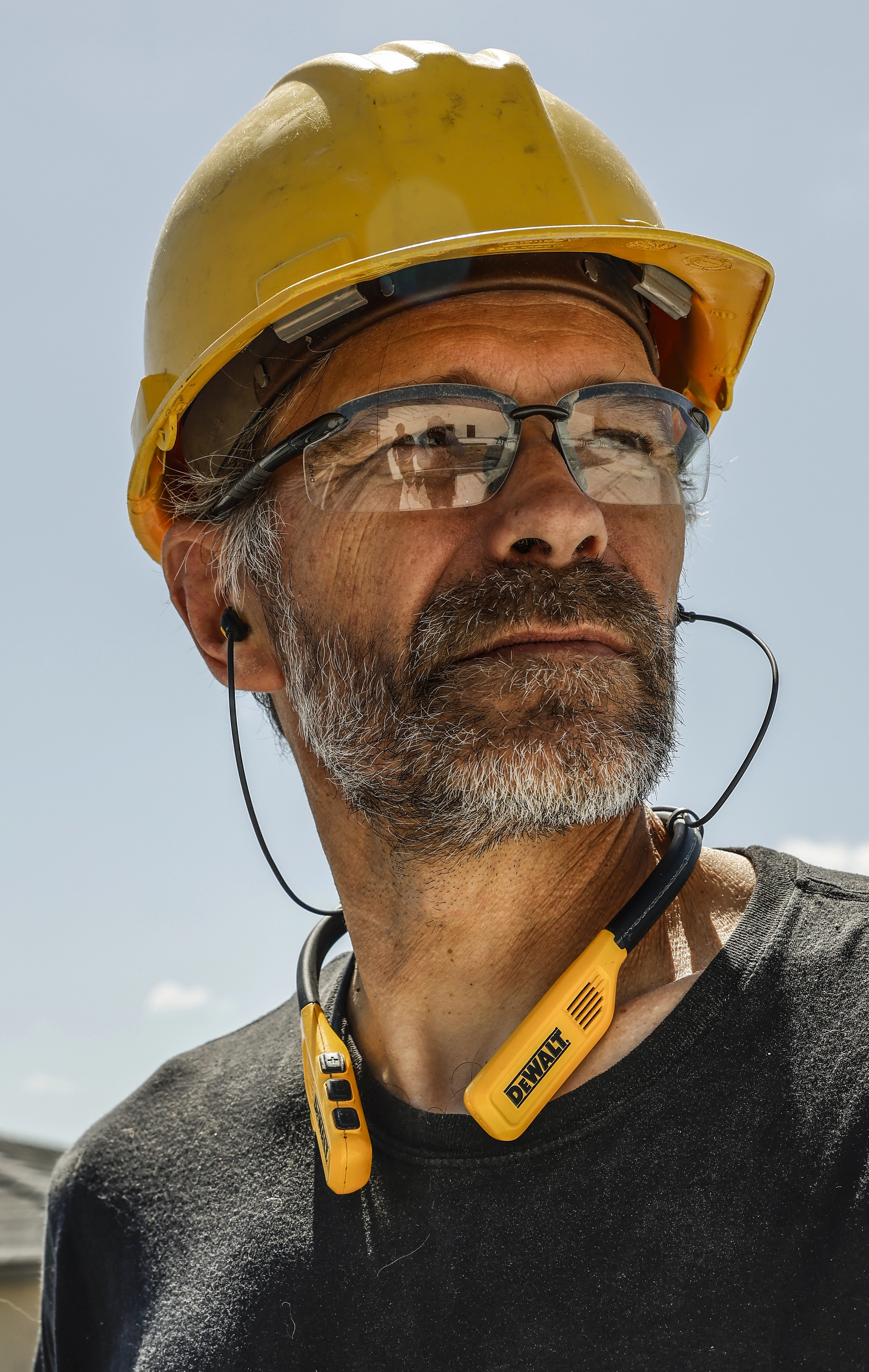 Worker wearing DEWALT licensed audio product