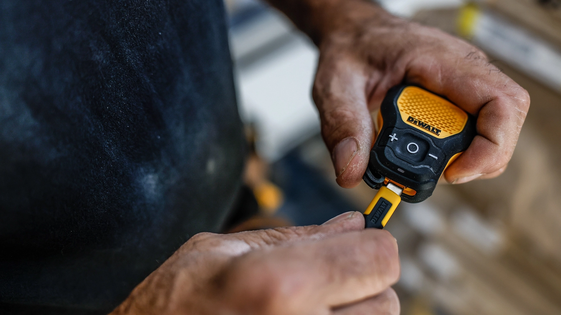 DEWALT wearable speaker with USB-C cable being plugged in